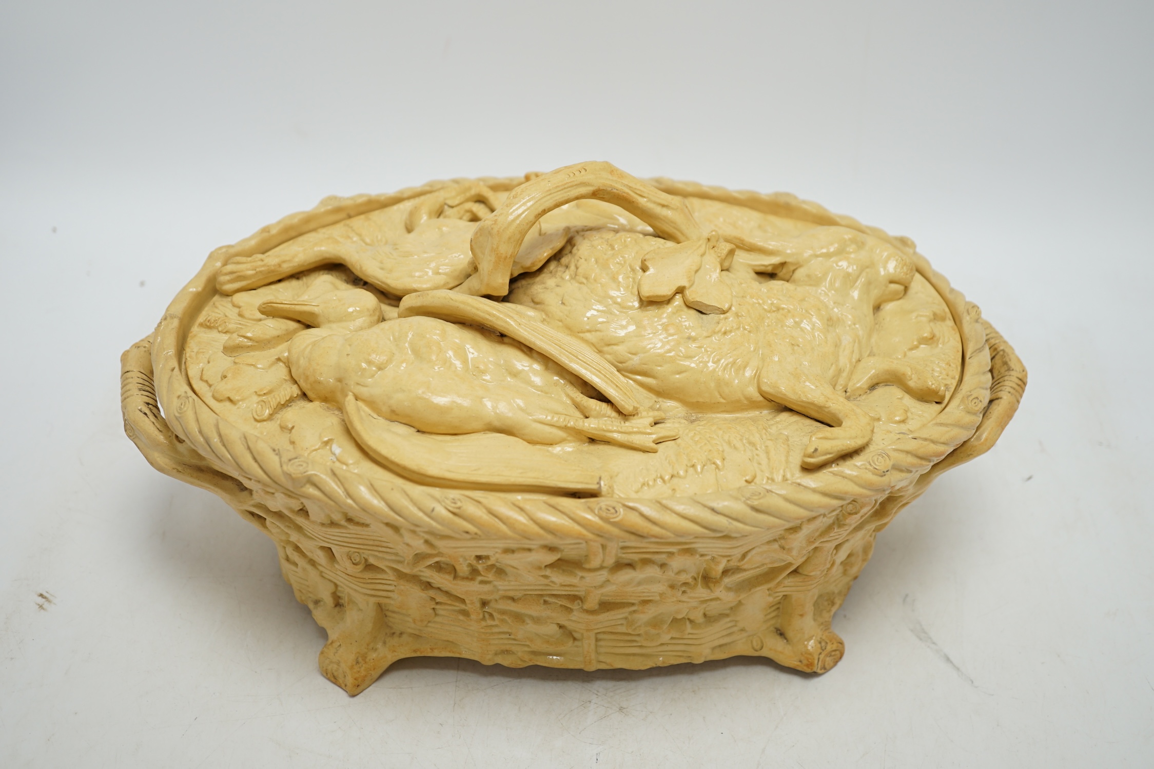 A 19th century Minton caneware game pie dish and cover, 33cm wide. Condition - acorn leaf tip and wing tip missing on cover, small chips to inner lip of tureen.